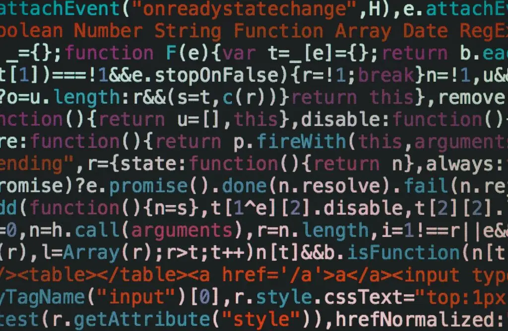 Close-up of colorful coding text on a dark computer screen, representing software development.